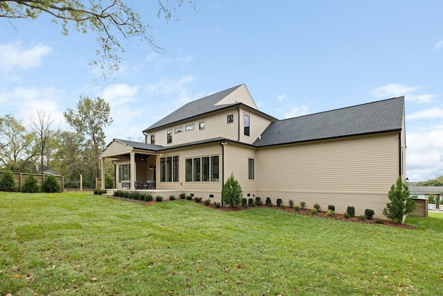 back of house with a lawn and a patio area