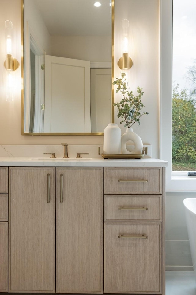 bathroom featuring vanity and a tub