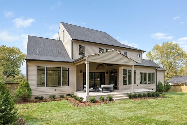 rear view of house featuring a patio and a lawn