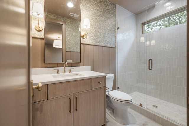 bathroom with wooden walls, toilet, vanity, and walk in shower