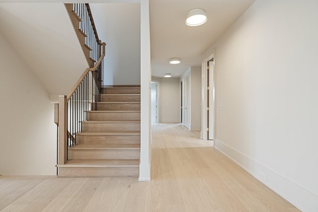 stairway with hardwood / wood-style flooring