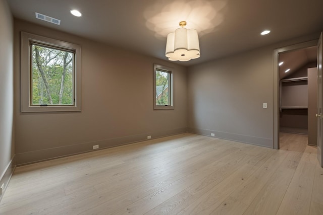 spare room with light hardwood / wood-style flooring