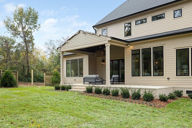 back of house featuring a yard, a patio, and an outdoor hangout area