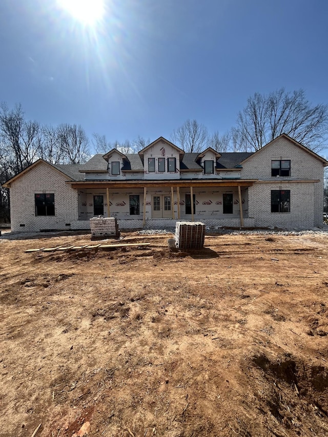 back of house featuring cooling unit and covered porch