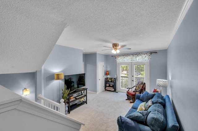 living room with ceiling fan, crown molding, light carpet, and french doors