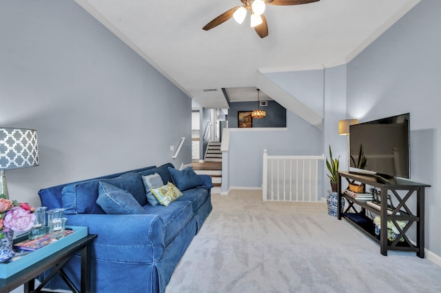 living room featuring carpet flooring, ceiling fan, and ornamental molding