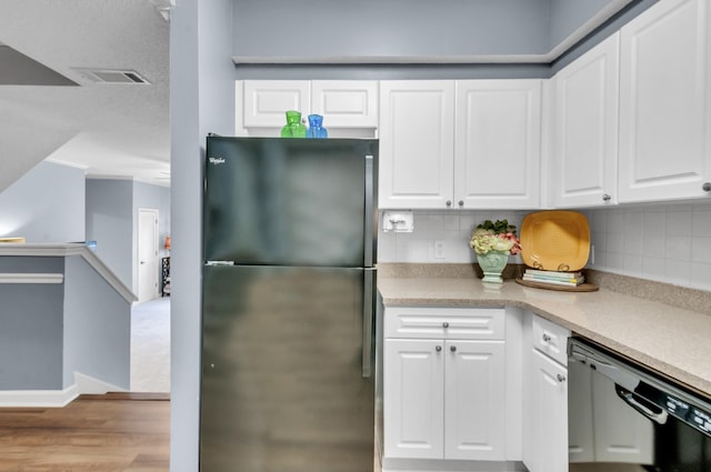 kitchen featuring white cabinetry, dishwasher, backsplash, fridge, and light wood-type flooring