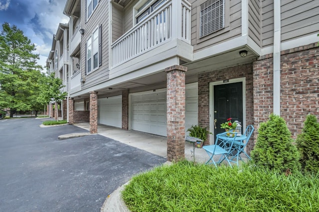 exterior space featuring a balcony and a garage