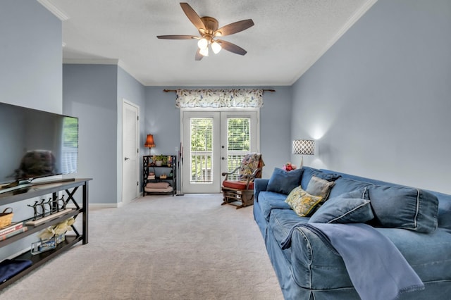 carpeted living room with ceiling fan, french doors, a textured ceiling, and ornamental molding