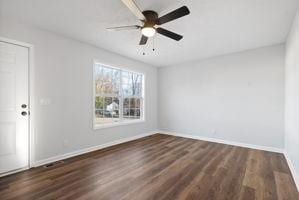 unfurnished room with ceiling fan and dark wood-type flooring