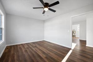 empty room featuring ceiling fan and dark wood-type flooring