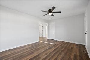 unfurnished bedroom featuring ceiling fan and dark wood-type flooring