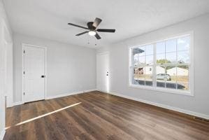 interior space with dark hardwood / wood-style flooring, a wealth of natural light, and ceiling fan