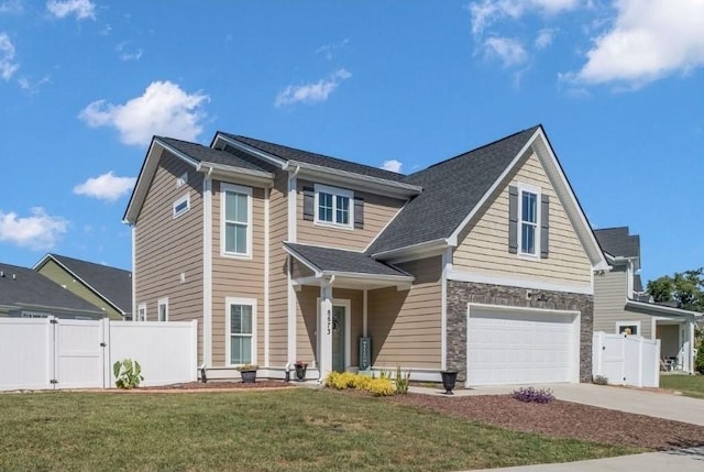 view of front of property with a garage and a front lawn