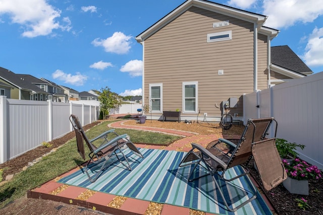 rear view of property with a lawn