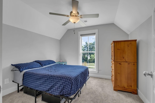 carpeted bedroom with vaulted ceiling and ceiling fan