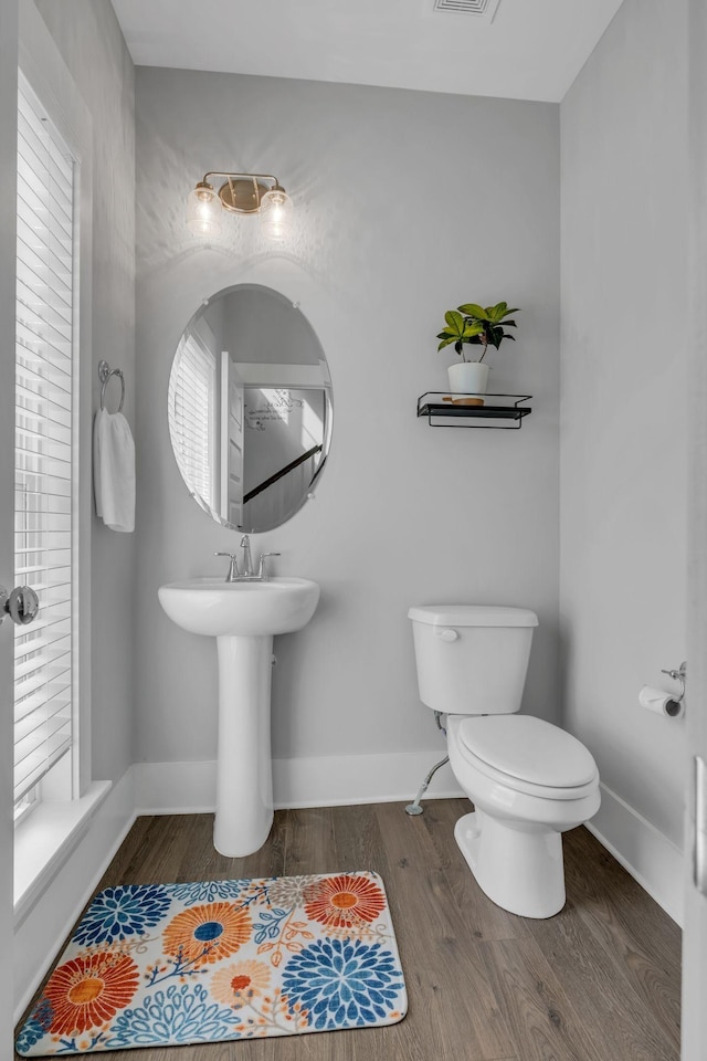 bathroom featuring hardwood / wood-style floors and toilet