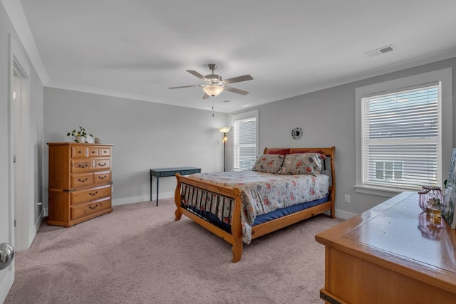 bedroom featuring light carpet, ceiling fan, and crown molding