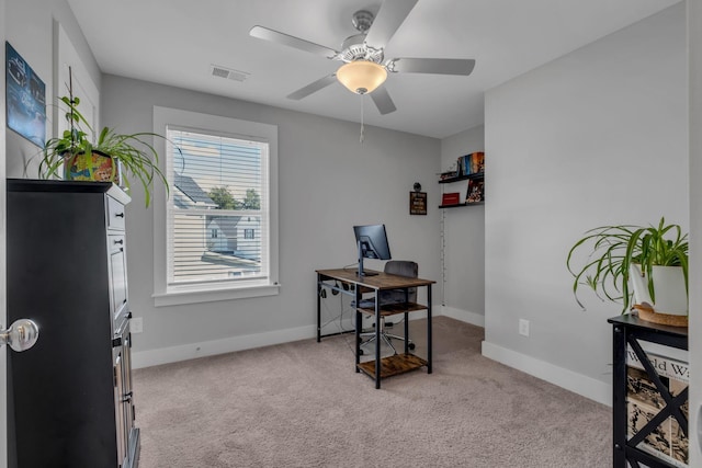 office space featuring ceiling fan and light colored carpet