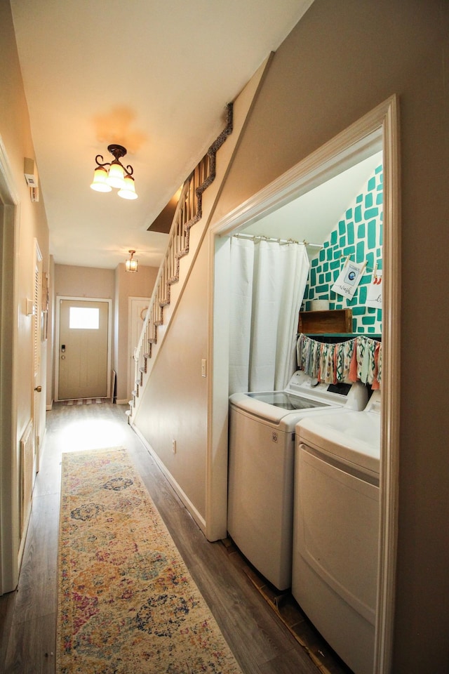 laundry room featuring dark hardwood / wood-style flooring and washer and clothes dryer