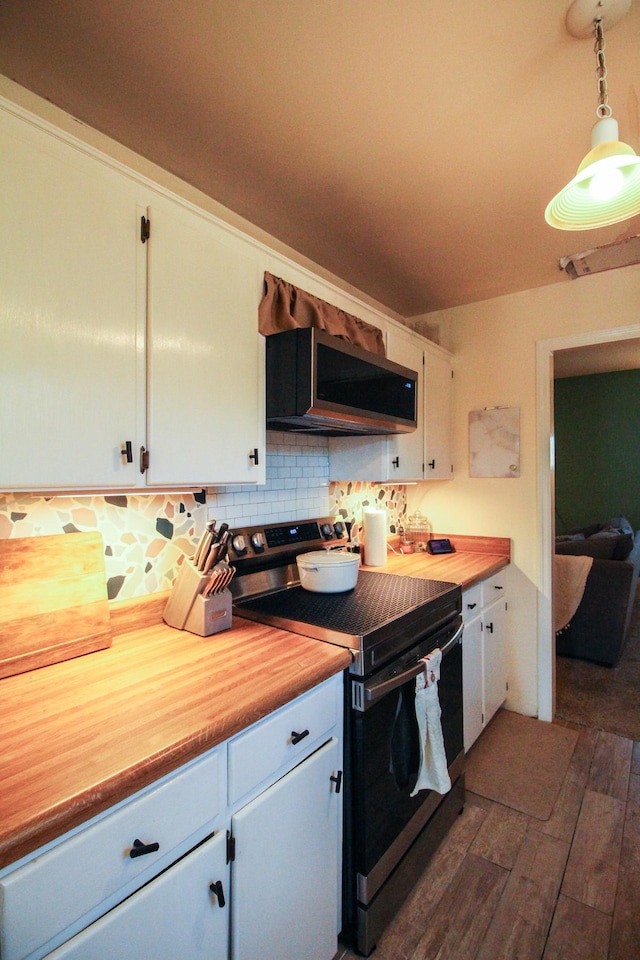 kitchen with backsplash, appliances with stainless steel finishes, hanging light fixtures, and white cabinets