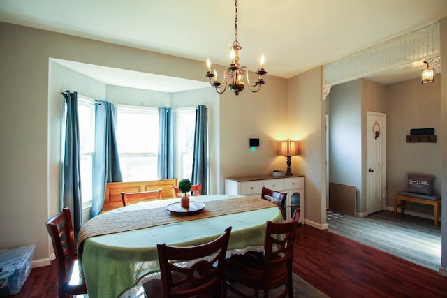 dining room featuring an inviting chandelier and dark hardwood / wood-style flooring