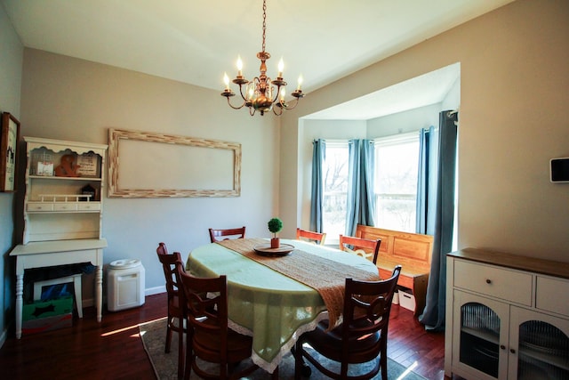 dining area featuring a notable chandelier and dark hardwood / wood-style floors