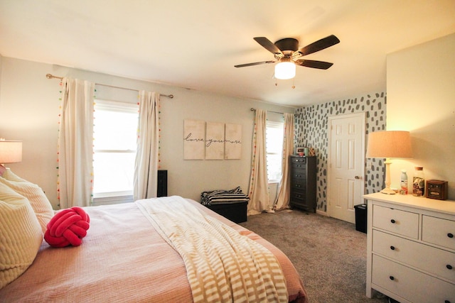 carpeted bedroom with multiple windows and ceiling fan