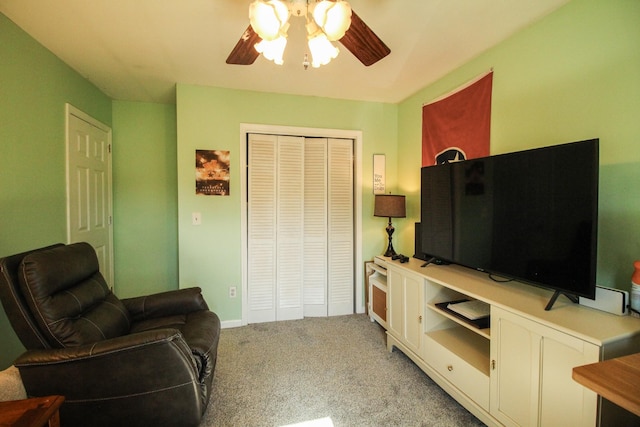 living room featuring ceiling fan and light colored carpet