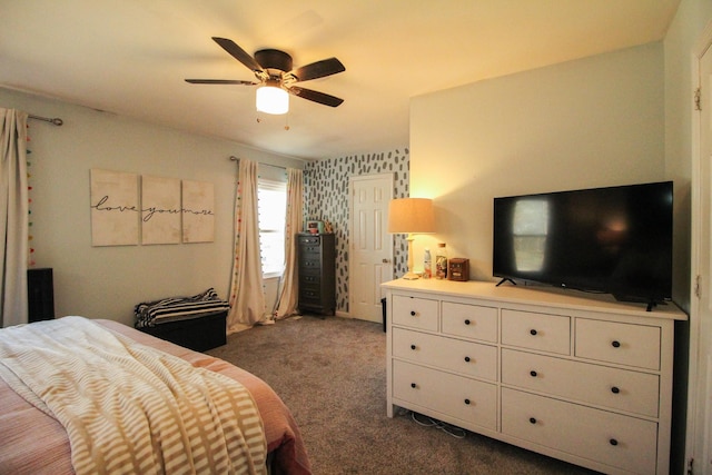 bedroom with ceiling fan and dark carpet