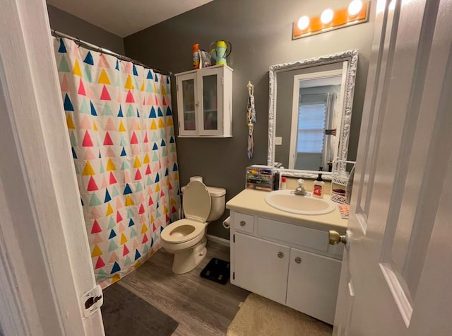 bathroom featuring a shower with shower curtain, vanity, toilet, and hardwood / wood-style floors