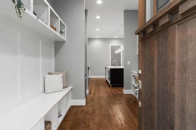 mudroom with dark hardwood / wood-style flooring and sink