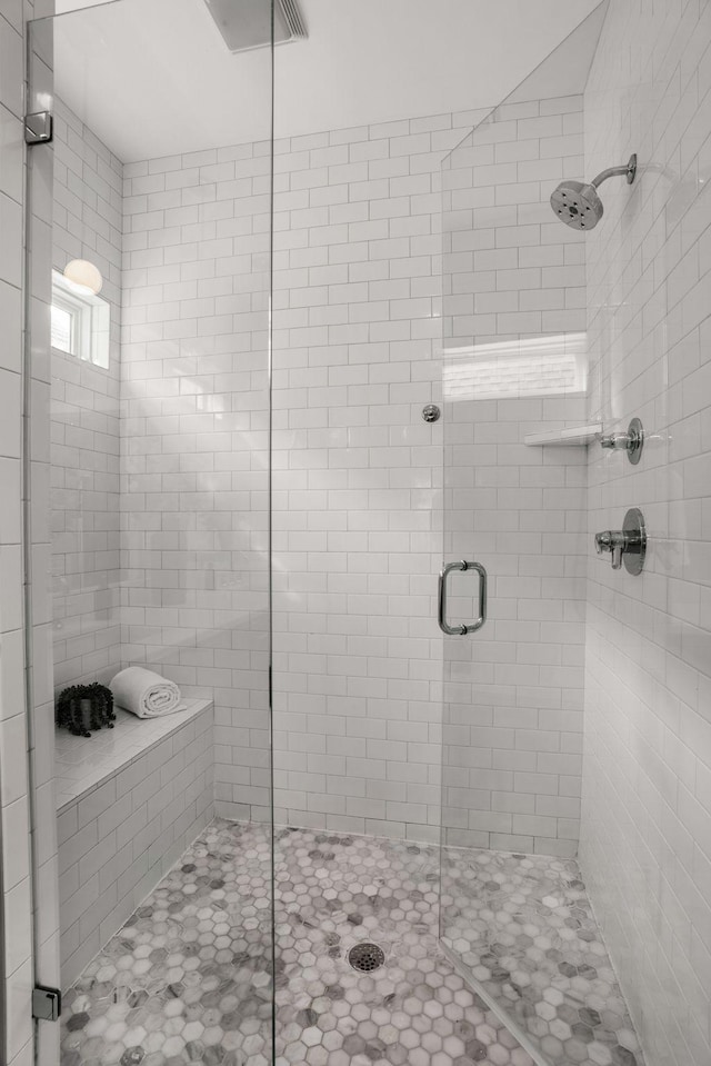 bathroom featuring a shower with door