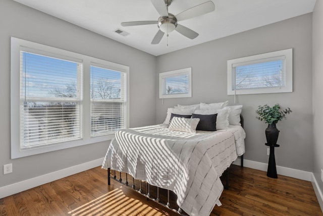 bedroom with ceiling fan and dark wood-type flooring