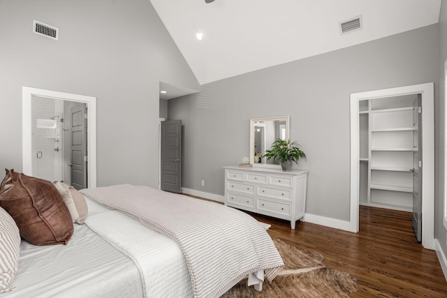 bedroom featuring ensuite bath, a walk in closet, high vaulted ceiling, and a closet