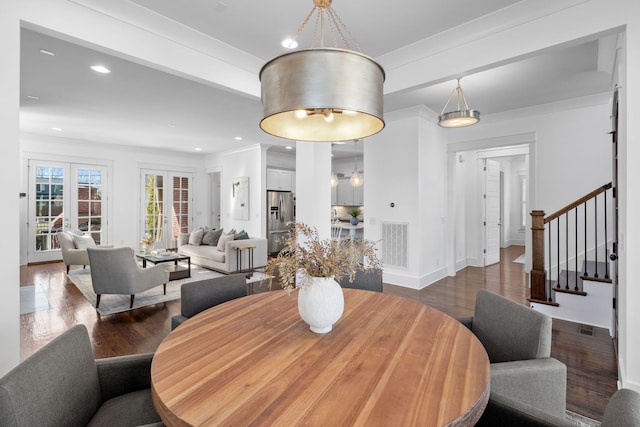 dining area featuring french doors, dark hardwood / wood-style flooring, and ornamental molding