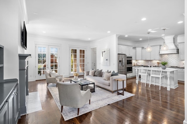 living room with sink, crown molding, dark wood-type flooring, and french doors