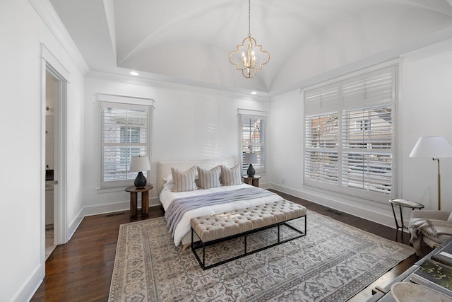 bedroom featuring dark hardwood / wood-style floors, vaulted ceiling, and an inviting chandelier