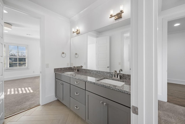 bathroom featuring parquet floors, vanity, and ornamental molding