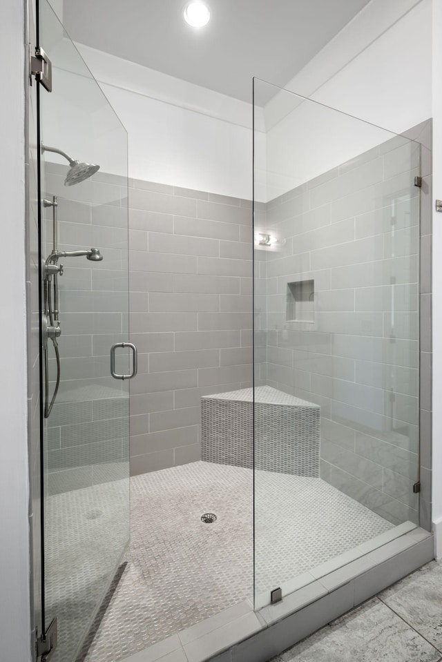 bathroom with tile patterned flooring and a shower with door