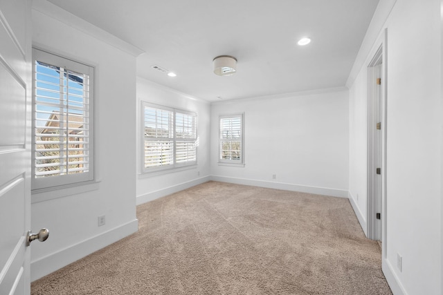 unfurnished room with light carpet and crown molding