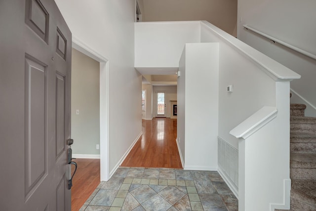 foyer entrance with a towering ceiling