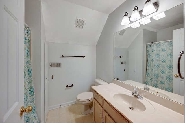 bathroom featuring vanity, toilet, and vaulted ceiling