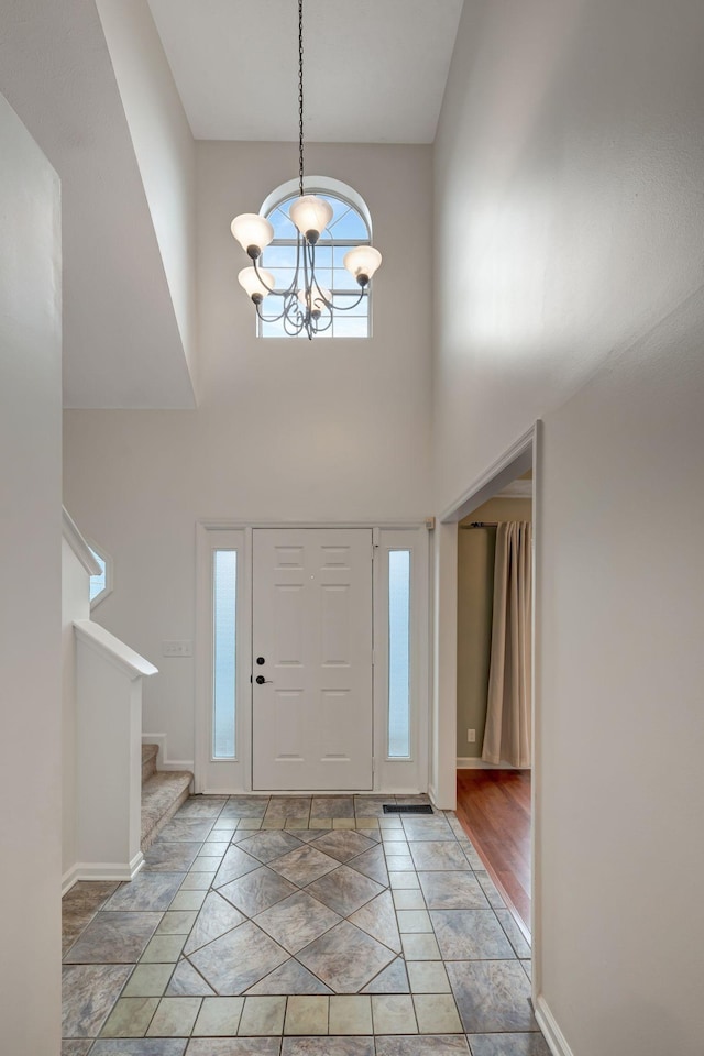 foyer entrance featuring a high ceiling and an inviting chandelier