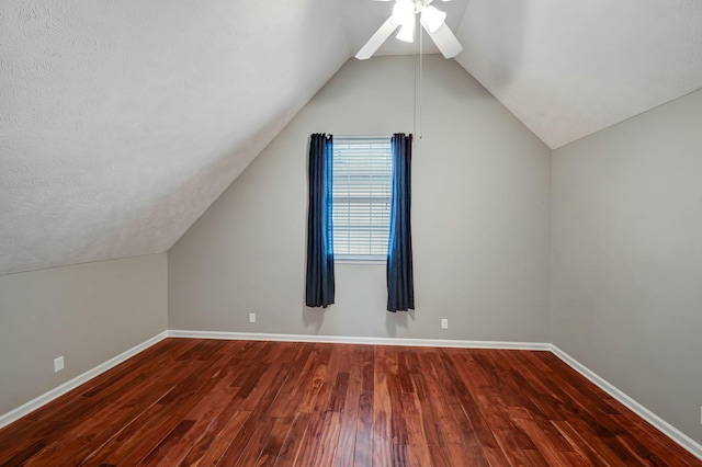 additional living space featuring ceiling fan, dark hardwood / wood-style flooring, and lofted ceiling