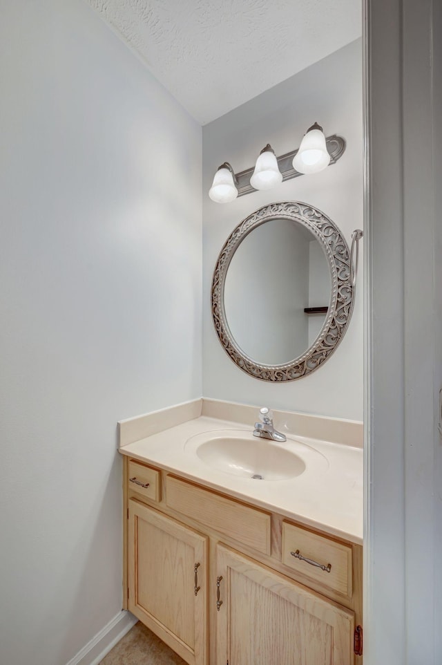 bathroom featuring vanity and a textured ceiling