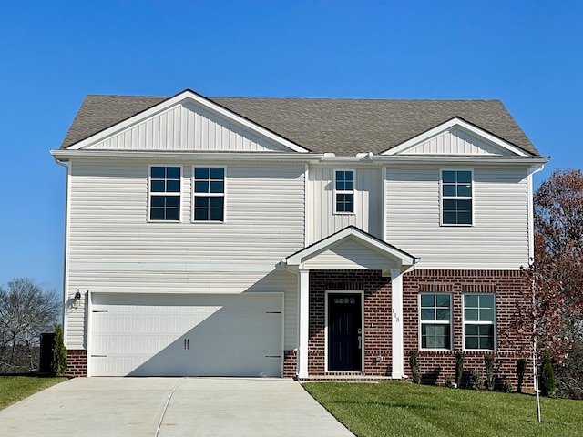 view of front of property featuring a garage and a front lawn