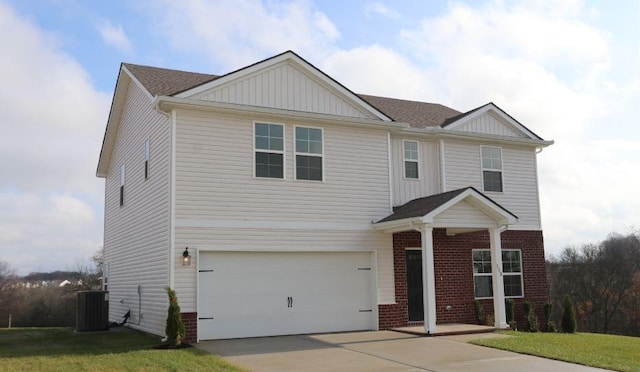 view of front of house featuring a front yard, a garage, and central air condition unit