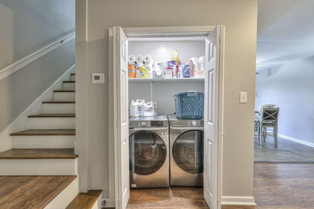 laundry room with dark hardwood / wood-style flooring and washer and clothes dryer