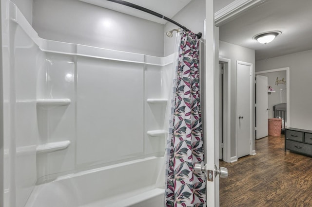 bathroom with shower / bath combo and hardwood / wood-style flooring